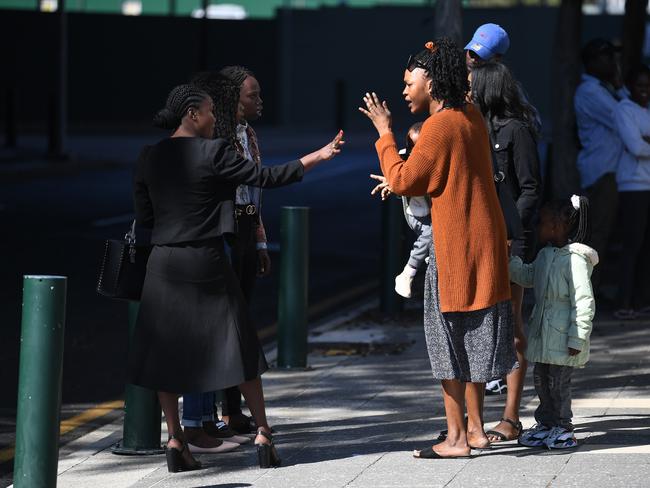 Family and friends of ten men charged over the deadly gang attack at Zillmere are seen arguing outside the Magistrates Court in Brisbane. Picture: NCA NewsWire / Dan Peled