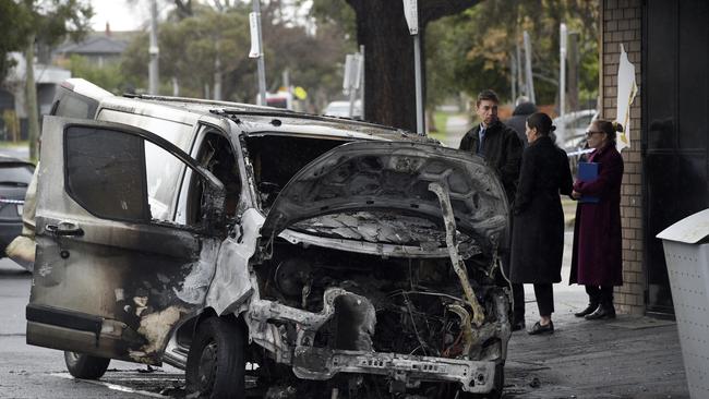 A torched van outside a tobacconist shop on Belair Ave, Glenroy. Picture: Andrew Henshaw