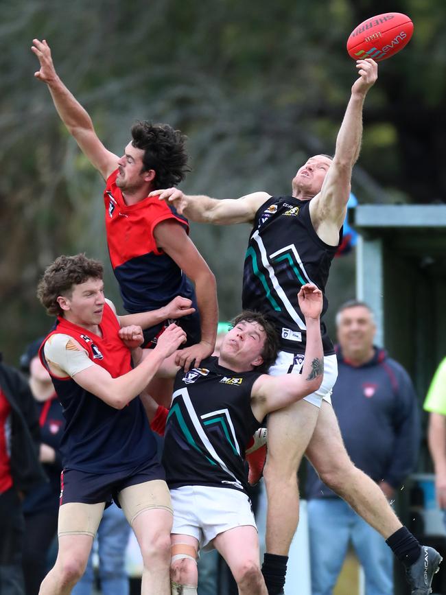 Swifts Creek’s Beau Hack and Omeo-Benambra’s Cameron Roberts fly for the ball.