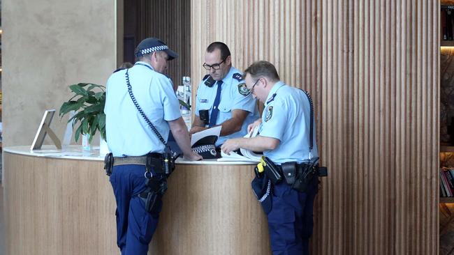 Police go through paperwork at Rydges Hotel. Picture: Matrix