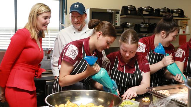 Waterford MP Shannon Fentiman and chef Matt Golinski watch as Beenleigh State High School students put the finishing touches on their Paddock to Plate lunch.