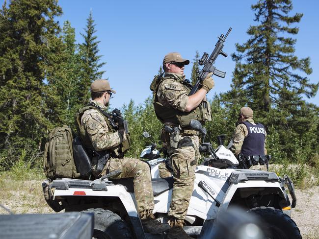 Members of the Royal Canadian Mounted Police Emergency Response Team prepare to search an area near where the burned out Toyota Rav 4 driven by murder suspects Kam McLeod and Bryer Schmegelsky was found. Picture: Angus Mordant