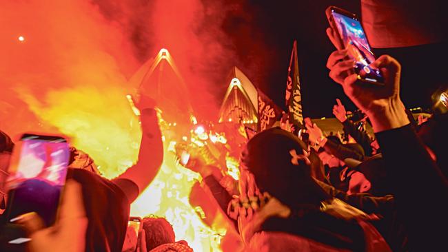 Pro-Palestinian marchers burn an Israeli flag at the Sydney Opera House on October 9 last year. Picture: NCA Newswire/Jeremy Piper