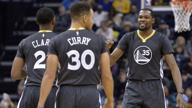 Golden State Warriors players Ian Clark, Stephen Curry and Kevin Durant.