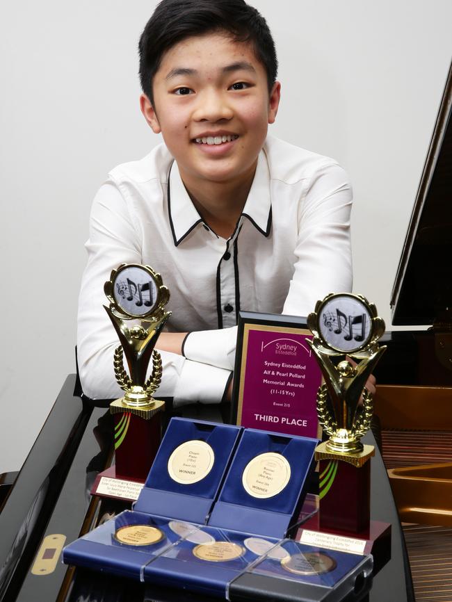 Joshua Han with his medals and awards.