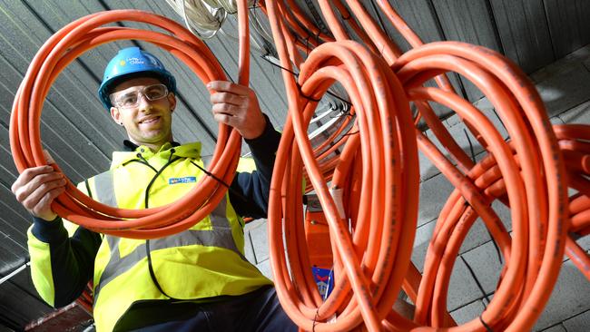 An apprentice electrician working on site.