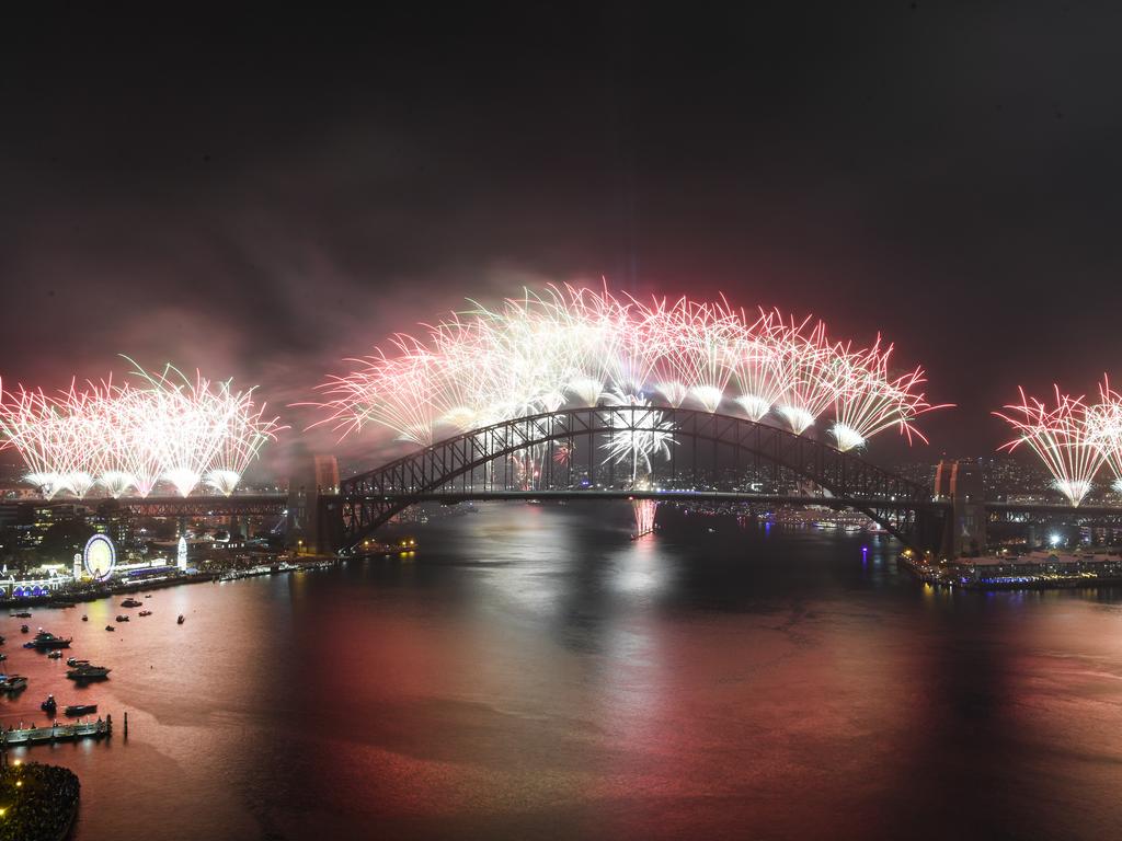 The Midnight fireworks explode over the Sydney Harbour Bridge on Sydney Harbour during the Year's Eve celebrations in Sydney, Tuesday, December 31, 2019. (AAP Image for City of Sydney/Lukas Coch)