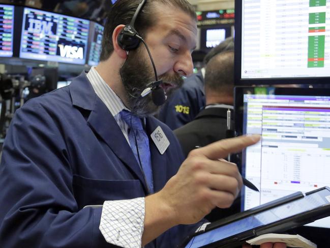 Trader Greg Mulligan works on the floor of the New York Stock Exchange, Friday, Oct. 23, 2015. Technology shares are surging in early trading after several big-name companies reported big earnings gains. (AP Photo/Richard Drew)