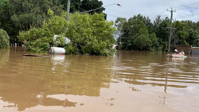A paddler inspects damage on March 1, 2022, a day after Lismore was hit by a record flood. Picture: Stuart Cumming