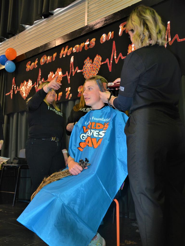 At the St Joseph's College 2023 World's Greatest Shave event is student Emily Chandler getting her hair cut by her support crew and hairdresser Natalie Schmidt from the Hair Room on Russell. Picture: Rhylea Millar