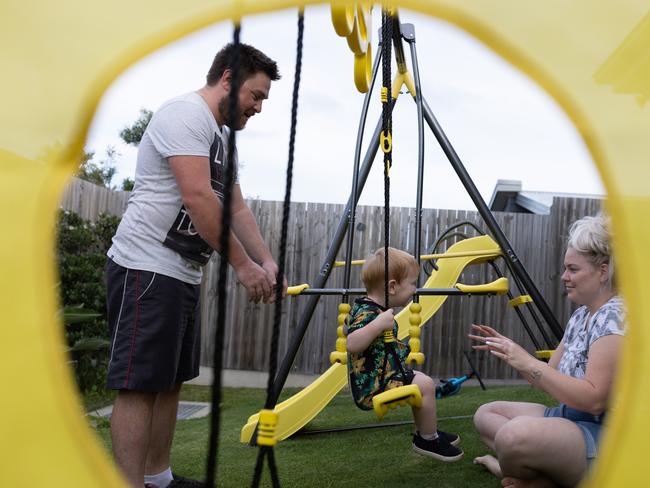 Aaron and Nikki play with Jaxon in their backyard. Picture: David Kelly