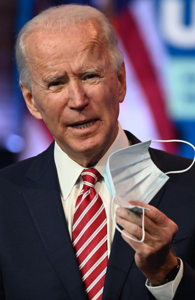 US President-elect Joe Biden shows a face mask as he answers questions about COVID-19 in Wilmington, Delaware. Picture: AFP