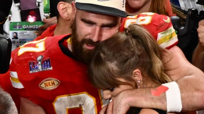(FILES) US singer-songwriter Taylor Swift and Kansas City Chiefs' tight end #87 Travis Kelce embrace after the Chiefs won Super Bowl LVIII against the San Francisco 49ers at Allegiant Stadium in Las Vegas, Nevada, February 11, 2024. Kelce is helping survivors of the shooting that marred the Kansas City Chiefs' Super Bowl victory parade, after his world-famous girlfriend Swift did the same, NBC news reported on February 17, 2024. The shooting on February 14 left one woman dead and 22 people injured â including two girls in the Reyes family. Kelce's Eighty-Seven Running foundation made two $50,000 donations to a GoFundMe raising money to support the Reyes family, a Kelce representative confirmed to NBC. (Photo by Patrick T. Fallon / AFP)