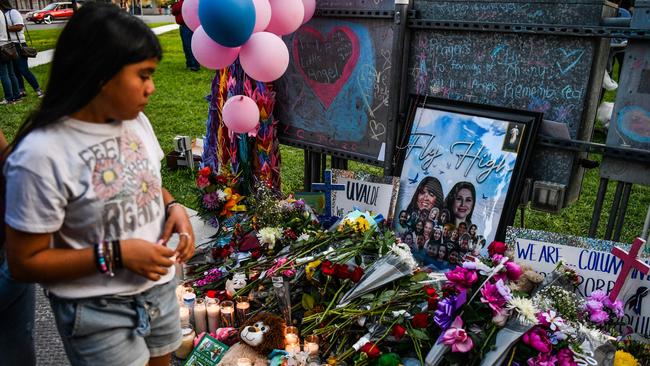 A girl visits a makeshift memorial for the shooting victims outside the Uvalde County Courthouse in Texas on May 28, 2022. Picture:: Chandan Khanna / AFP)