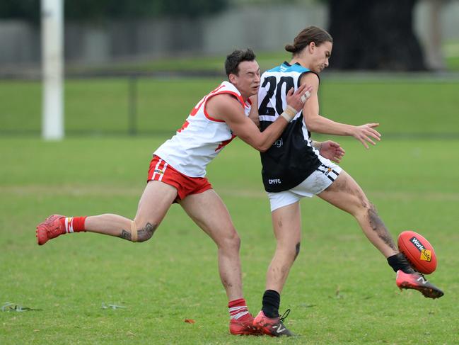 Crib Point’s Declan Gould gets his kick away as Karingal’s Mason Russell applies pressure. Picture: Chris Eastman