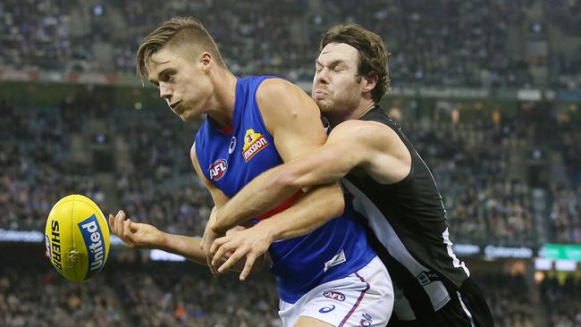 Western Bulldog Josh Schache tackled by Collingwood's Matthew Scharenberg. Picture: Michael Klein