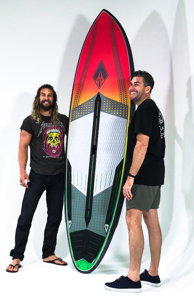 Aquaman Jason Momoa with Gold Coast surf shop owner Tim Beban designing their custom board together. 