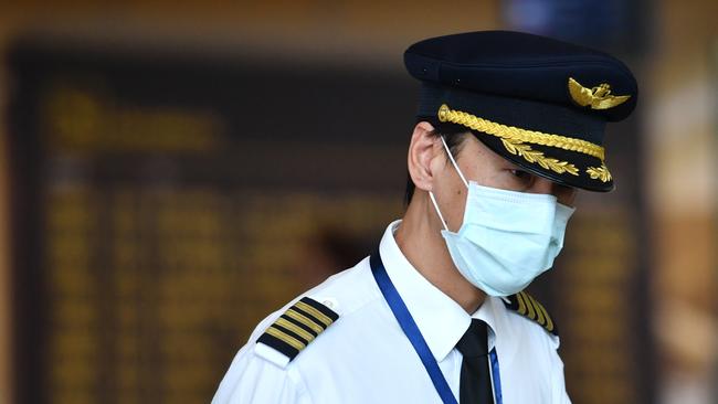 Airline cabin crew seen wearing face masks in Brisbane International Airport. Picture: AAP Image/Darren England