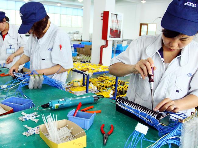 Chinese workers assembling computers in China’s Zhejiang province. Pic: AFP.