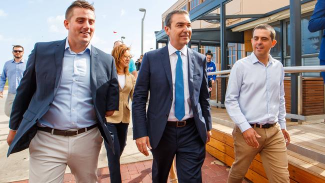 SA Liberal leader Steven Marshall after his victory in the state election with Matt Cowdrey (left) and Richard Harvey (right) at Henley Beach.