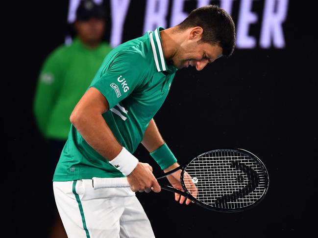 Serbia's Novak Djokovic struggles with an injury during the 2021 Australian Open.