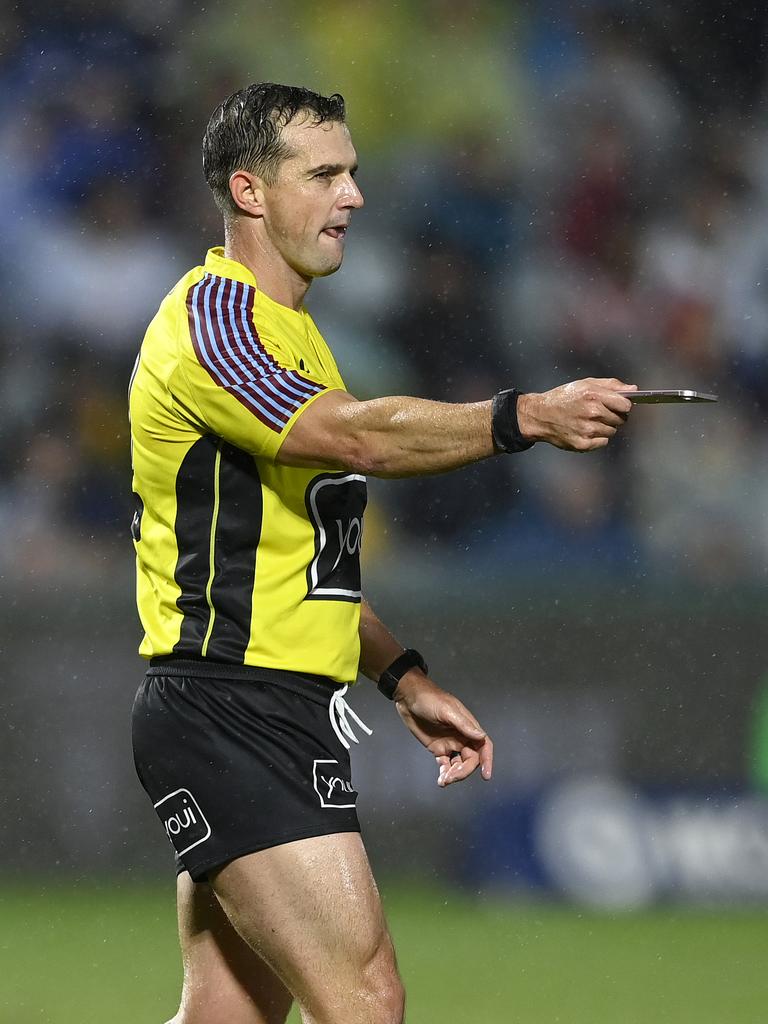 The pitch invader unintentionally forced a second stoppage after referee Grant Atkins spotted her phone on the field. Picture: NRL Imagery