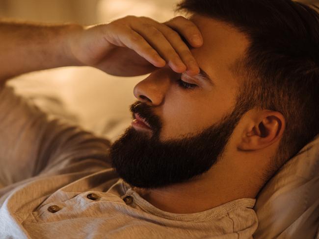 Worried young man reading bad news on smart phone