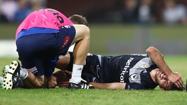 Melbourne Victory midfielder Terry Antonis lies in pain on the SCG turf after injuring his knee. Picture: AAP 