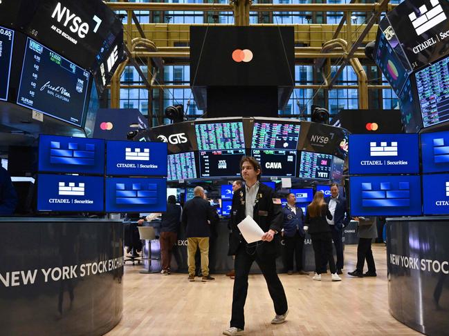 (FILES) In this file photo taken on November 13, 2024, traders work on the floor of the New York Stock Exchange (NYSE) at the opening bell in New York City. Wall Street stocks opened higher Monday as investors reacted positively to Donald Trump's Treasury Department pick at the start of a holiday-shortened week that will include economic data and earnings reports. (Photo by ANGELA WEISS / AFP)