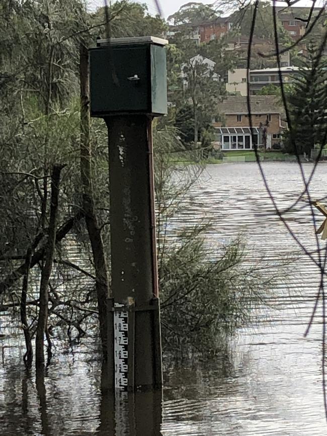 The flood gauge in Manly Lagoon, at the end of Riverview Pde, Manly, was already measuring close to 1.4m as water overlapping its banks on Wednesday morning. Picture: Jim O'Rourke