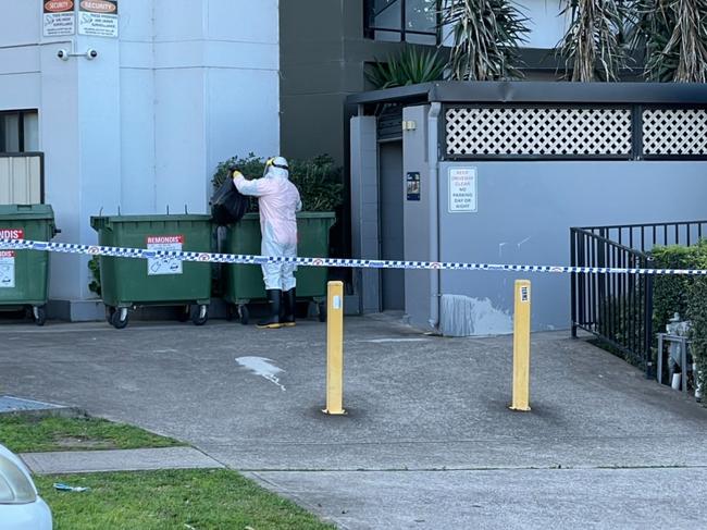 Cleaners kitted out in PPE on the scene. Picture: Ben Talintyre