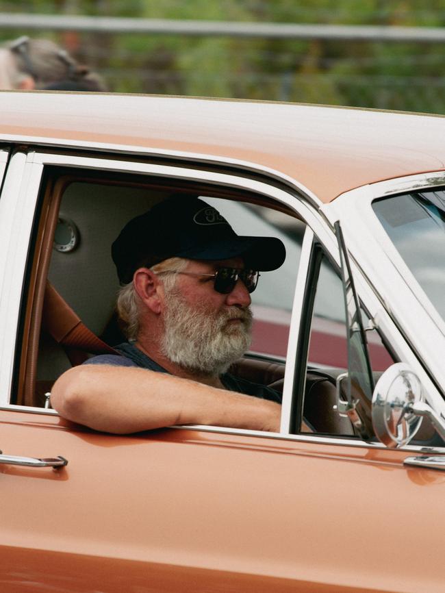 A vintage car enthusiast takes part in the parade at the 2023 Gayndah Orange Festival.