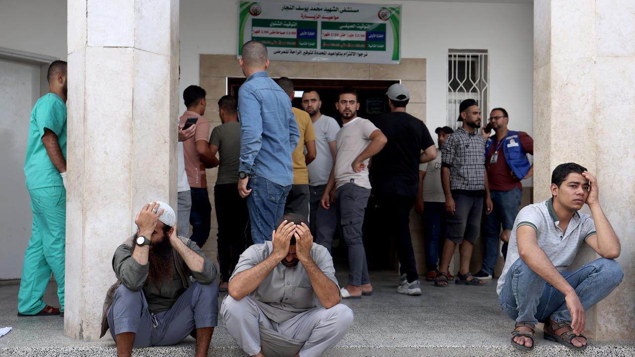 Distraught Palestinian men on the steps of a hospital following an Israeli air strike on buildings in Rafah, in the southern Gaza Strip. Picture: AFP