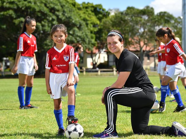 Pagewood Botany Football Club members Erin Jones and Coach Julia Chernoukha pose for a photo at Jellicoe Park in Pagewood, Sydney, Saturday, Nov. 11, 2017. (AAP Image/Joel Carrett)