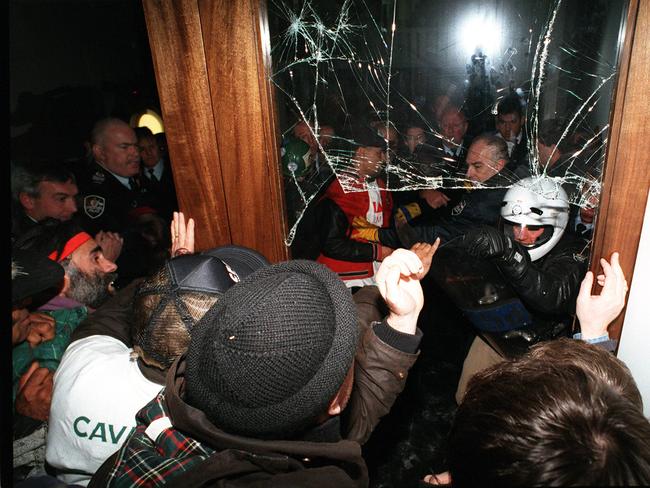 Police, security officers & protesters trade blows as they broke through cordons, protestors smashed through glass door of souvenir shop to gain access to inside of Parliament House, Canberra, rally organised by ACTU.  ACT / Demonstrations / Vandalism / Riot