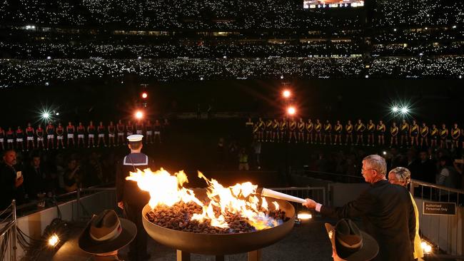 The lighting of the cauldron ahead of the Melbourne-Richmond clash. Picture: Wayne Ludbey