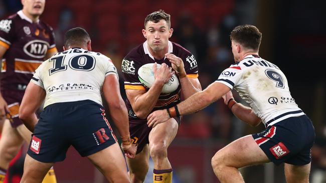 Corey Oates takes on the Roosters’ defence. Picture: Chris Hyde/Getty Images