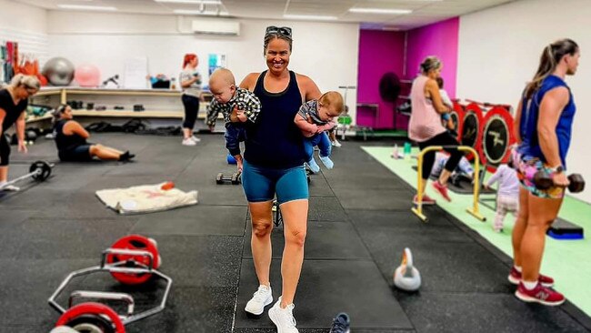 #1 Believe in Health and Fitness owner Hayley Warner holding two babies at the Mackay studio.