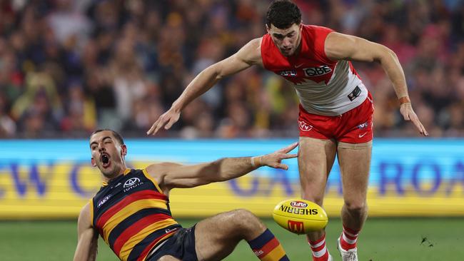 Taylor Walker and Tom McCartin compete for a loose ball. Picture: Sarah Reed/AFL Photos via Getty Images