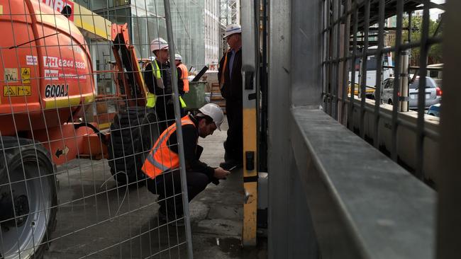 Lend Lease staff examine the gate that fell on two women at a work site on North Tce on Tuesday evening. Pic: Tait Schmaal