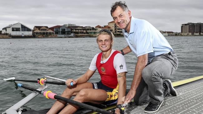 State rowing champion Oscar McGuinness with his dad and former Crows captain Tony McGuinness at West Lakes. Picture: Sarah Reed