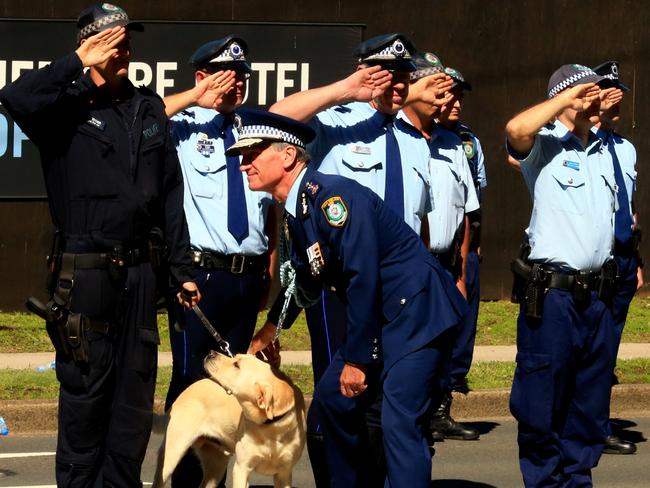 Police officers salute Andrew Scipione for the last time. Picture: Adam Taylor