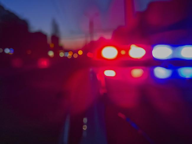 Red and blue Lights of police car in night time. Night patrolling the city. Abstract blurry image.