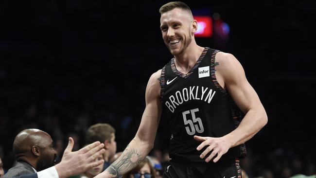 Mitch Creek high-fives the Brooklyn Nets bench after scoring in his NBA debut on Saturday. Picture: Sarah Stier (Getty).