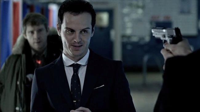 Andrew Scott as Moriarty in the UK series of Sherlock starring Benedict Cumberbatch with Martin Freeman’s Watson in the background.