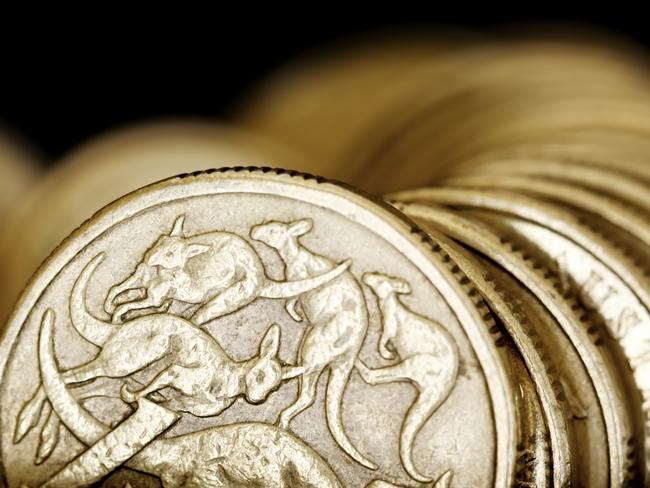 Australian one dollar coins over black background.