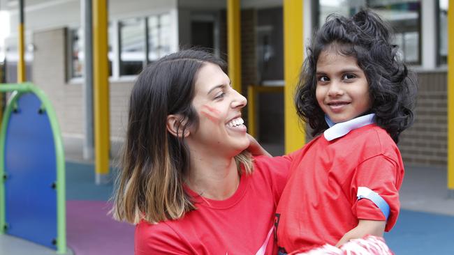 Genevieve Grace and Kingston Perera cheering for the Red Team.