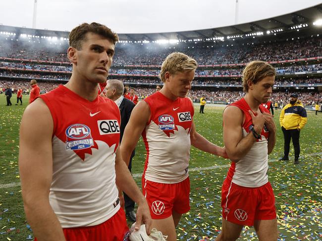 Robbie Fox, Heeney and James Rowbottom head from the field.