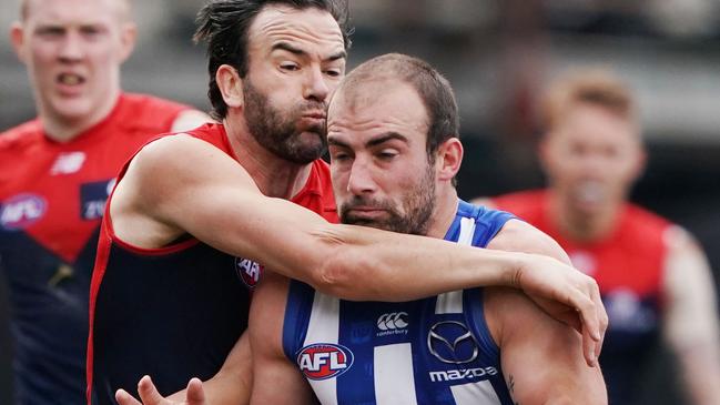 Last gamer Jordan Lewis collars North Melbourne midfielder Ben Cunnington.