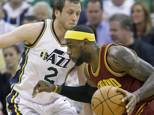 Cleveland Cavaliers' LeBron James (23) drives as Utah Jazz's Joe Ingles (2) defends in the second quarter during an NBA basketball game, Wednesday, Nov. 5, 2014, in Salt Lake City. (AP Photo/Rick Bowmer)